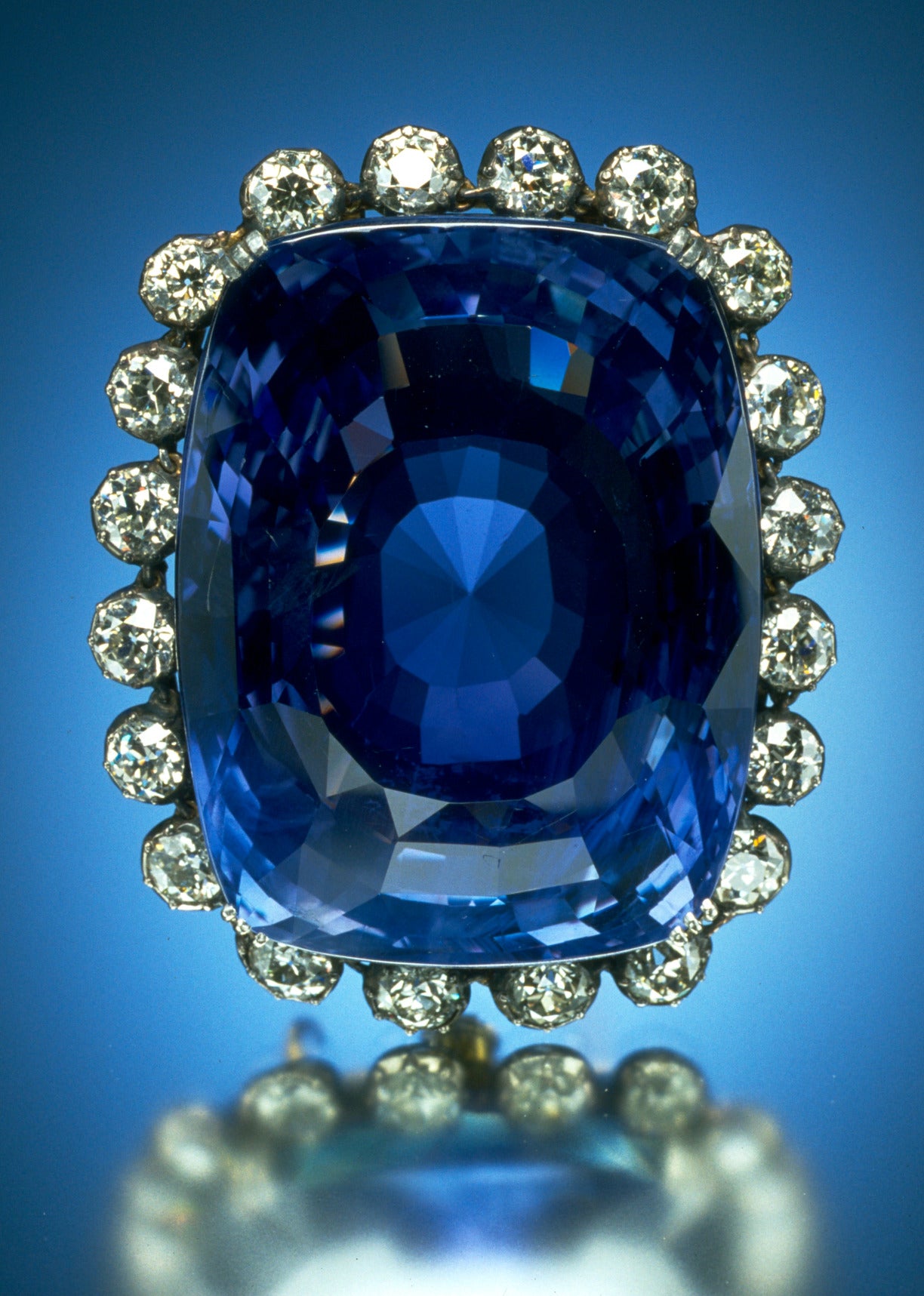 The blue Logan Sapphire and its diamond surround reflected below the brooch